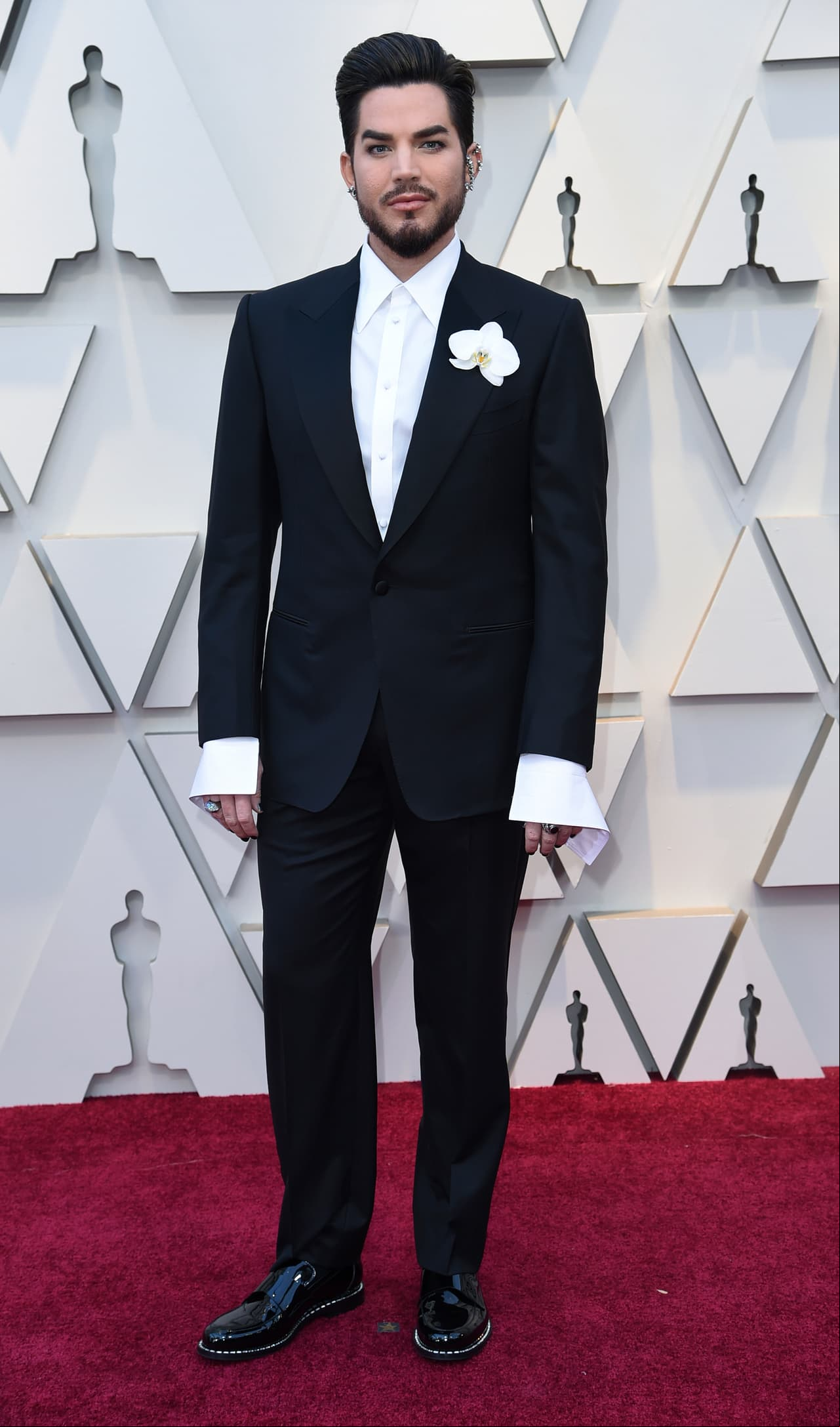 Adam Lambert eligió un traje negro, con una camisa de puños largos y zapatos de charol.