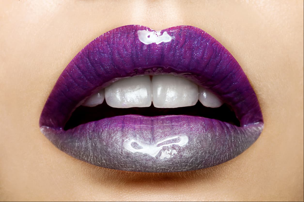 Beautiful female lips with a gradient of staining purple to silver