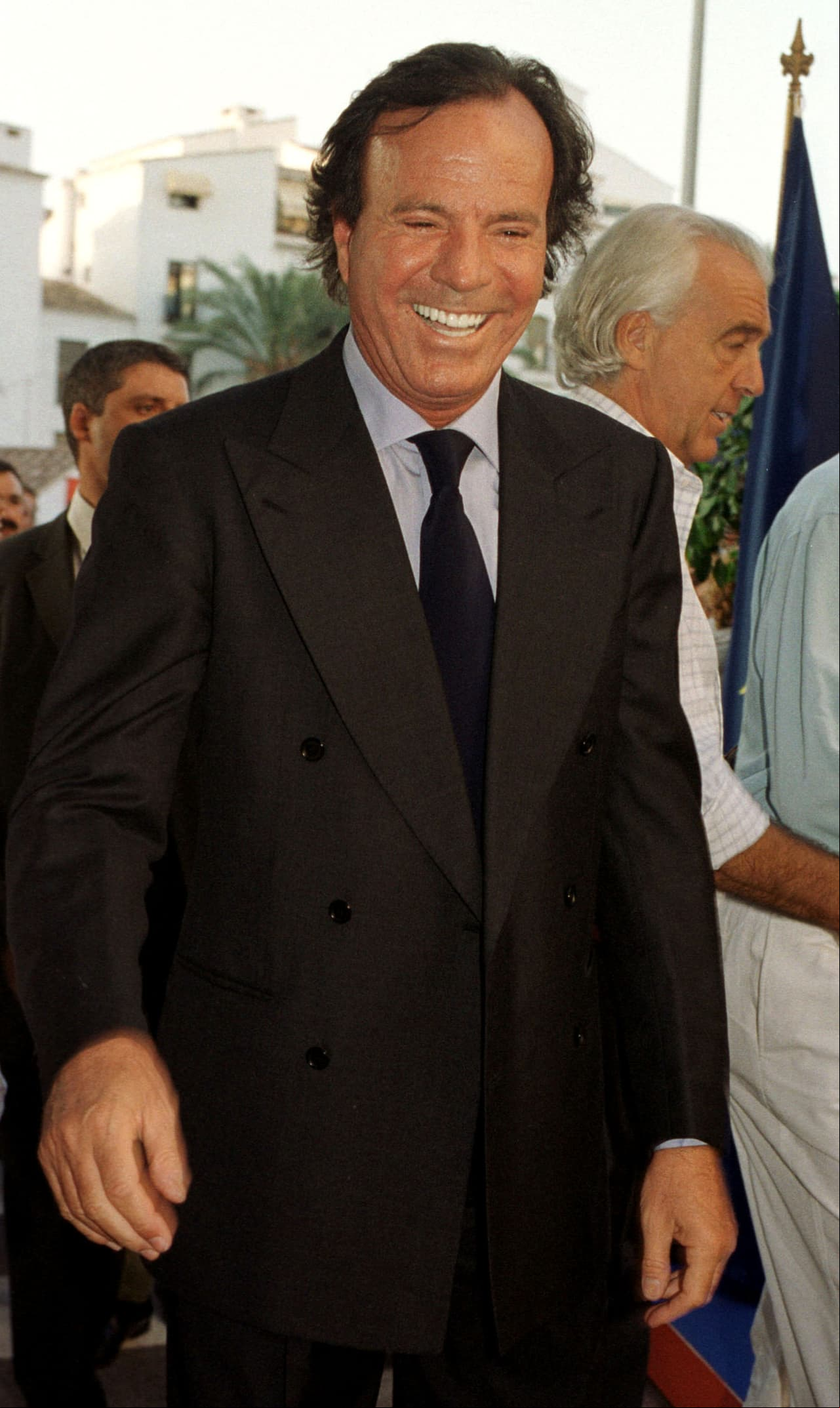 MALAGA, SPAIN - AUGUST 16: Singer Julio Iglesias smiles as he attends the opening of "Julio Igleias Avenue" August 16, 2002 in Puerto Banus, Marbella, Spain. (Photo by Carlos Alvarez/Getty Images)