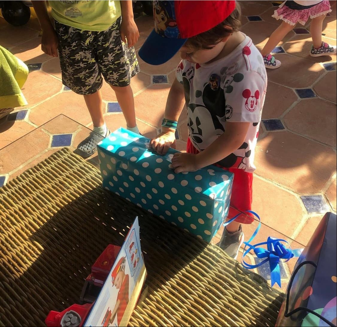 También se puede apreciar este tierno momento de José tratando de abrir uno de los osbequios que recibió por sus tres años de vida.