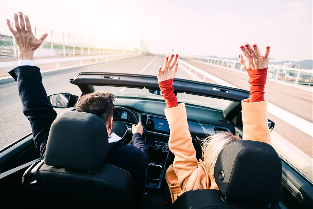 Middle age couple driving a car on road trip