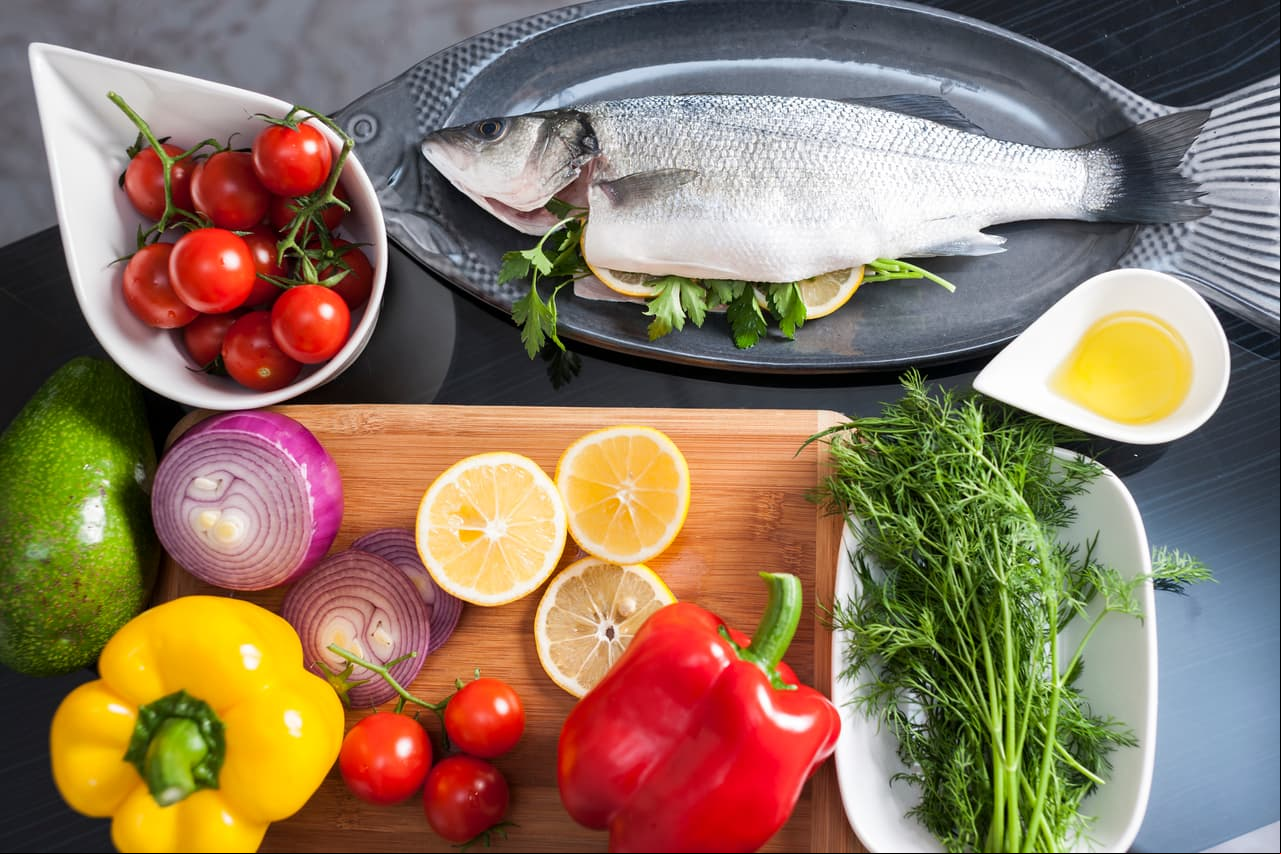 Raw uncooked sea bass with lemon, olive oil, herbs and spices